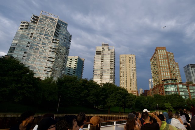 Sunlight illuminates the buildings under the clouds