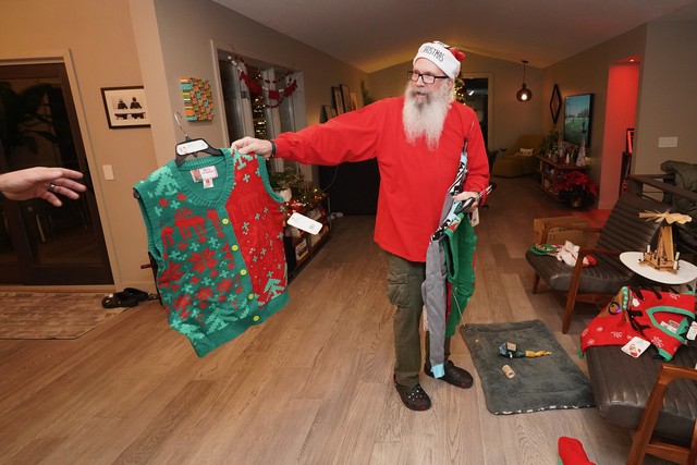 Santa handing out holiday sweaters