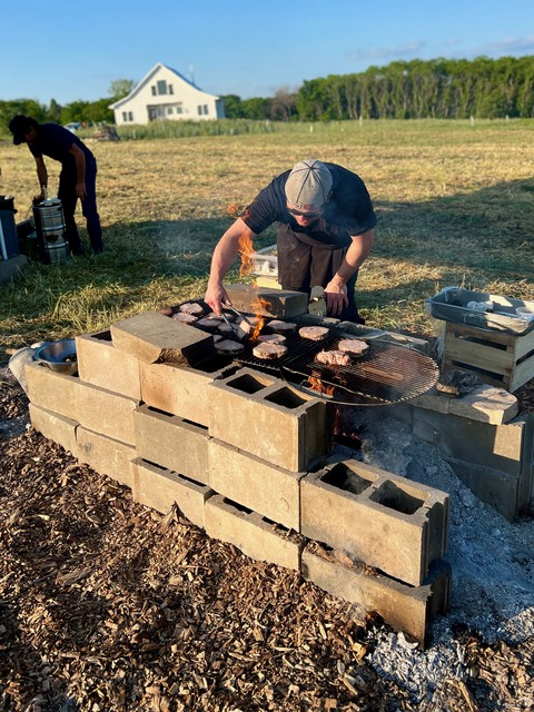 Tom cooking up the coppa steaks over the fire