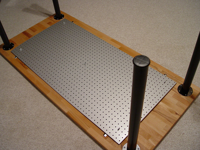 2 x 4 foot piece of peg board mounted to the bottom of my desk with 5 brackets