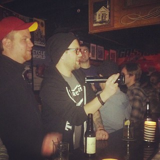 Using a maglite to see whats in the beer cooler... at the bar. Photo by Tia O'Brien