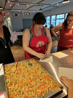 Our teacher showing us how to roll up some spring rolls