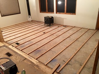 Sleepers ranging from 7/8" to 1.5" thick to raise the old porch floor up to the same height as the rest of the house... and make it level.