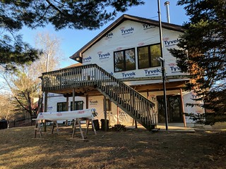The back patio opened up with tyvec wrapped around the back side