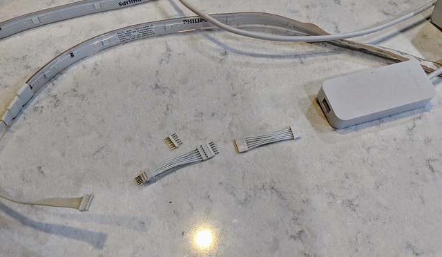 I later realized that the slightly older versions of hue light strips had a coupler that wasn't hard wired into the light strip. I happened to have 2 of the older ones, so, I found a company that made extensions for them and went that route. This way, if my hue ever dies, I still just have simple wires running through my wall and can easily switch things out.