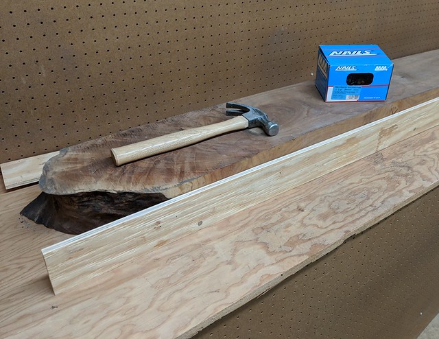 To square it up, I cut a couple straight pieces of plywood and tacked them to the sides with roofing nails (so they'd be easy to pry-back out). This would give me a straight edge to send through the planer. On the front-side, I tried to place the nails in sections of wood that I'd be planing off so the nail holes wouldn't be visible.