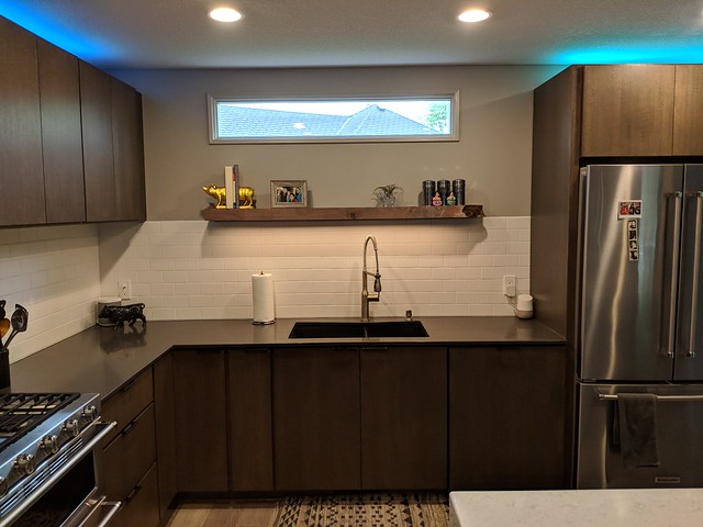 I probably could've shaved another 1/2" off of the thickness, but overall I think it turned out pretty well. It really helps frame the sink, cleans up the tile line, and balances out the wall. As a bonus, we later realized that the shadow cast by the live edge, kind of looks like the state of Iowa.