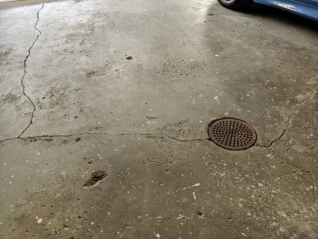 The gnarly old garage floor. Chipped up epoxy, with plenty of cracks, dimples, and divots