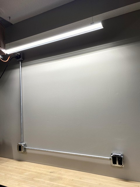 Surface mounted outlets and a light above the bench