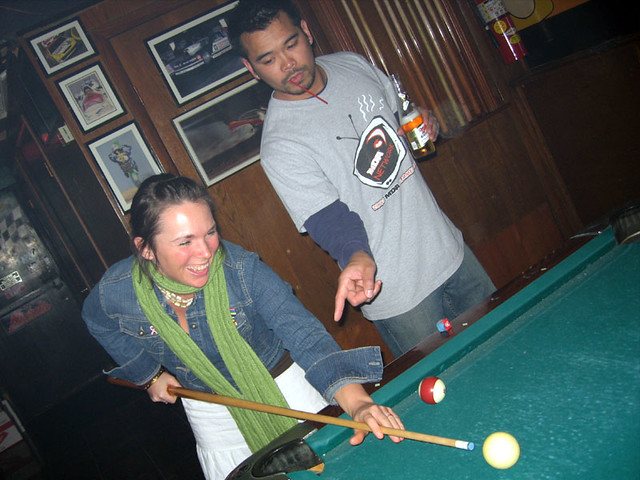 Nathan trying to show Kari how to play pool
