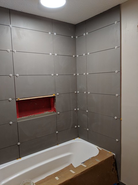 Shower tile up. Look at how that shelf fits right in there. That's some good planning by myself!