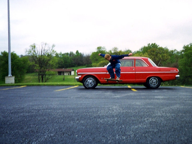 Seth Sample doing an ollie in front of my car at church
