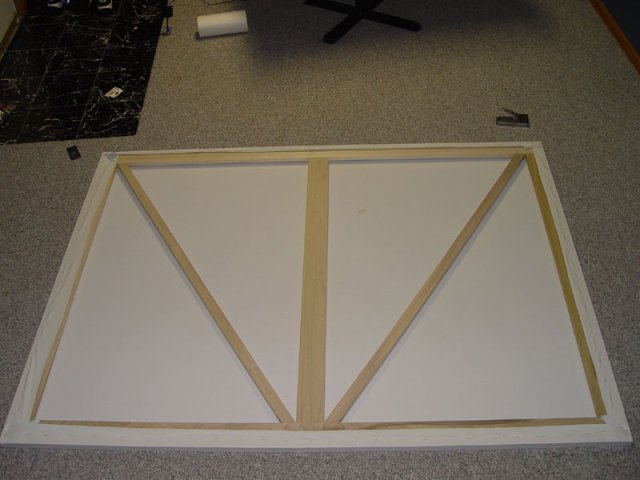 The screen material stapled to the frame