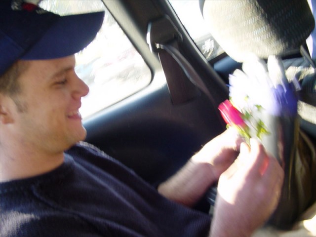 Tom pinning a rose on the boot
