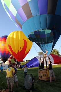 Fillin up some hot air balloons in the yard of a bank