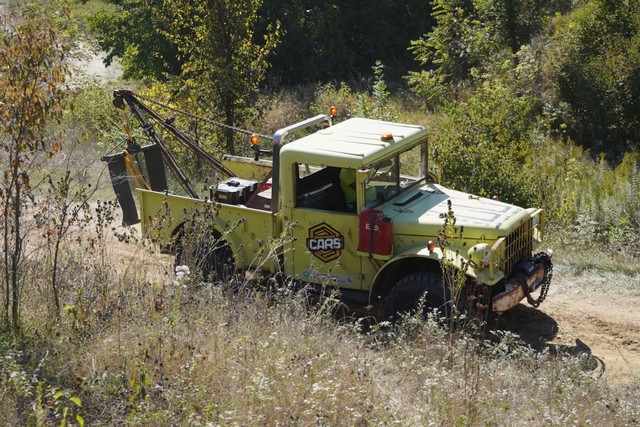 Off-road tow truck surveying the trail