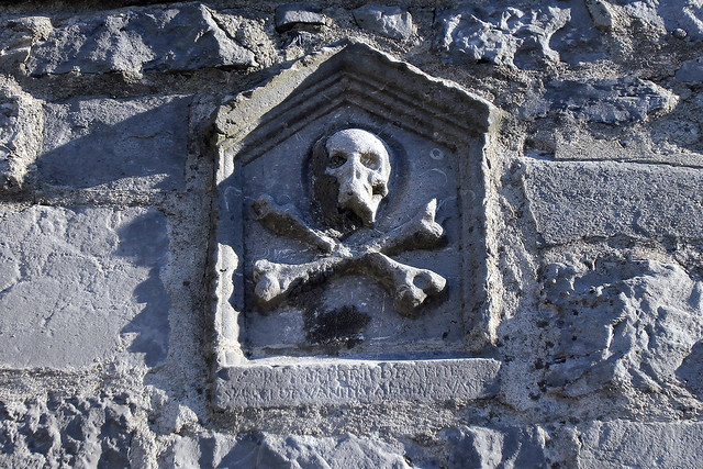 A pretty rad skull and crossbones emblem in an old stone wall in Galway