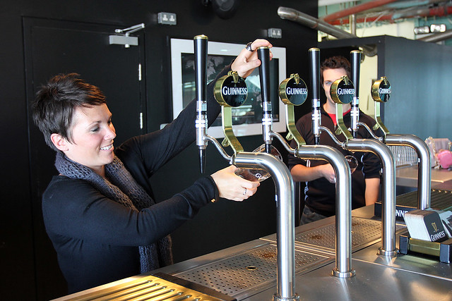 Kari learning how to pour a perfect pint of Guinness