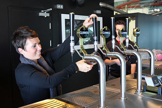 Kari learning how to pour a perfect pint of Guinness