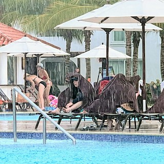 Jeff and Nina hide from the downpour