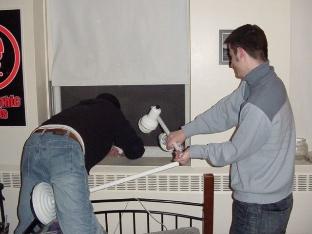 Putting Kevi's lamp out the window (Kevi was at Stacy's, whose dorm room can see our dorm room's window)