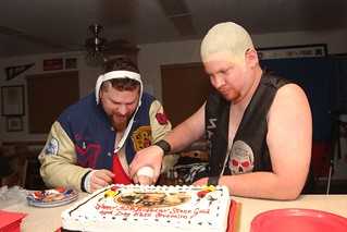 Stone Cold and the Dog Face Gremlin cutting the cake