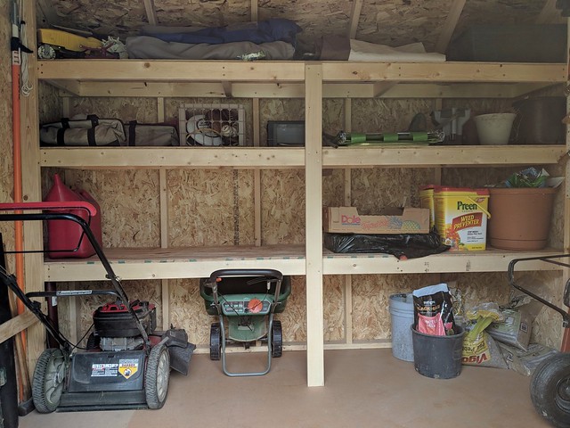 These shelves were much needed. I built the bottom shelf high enough to slip the mower and other push tools under.