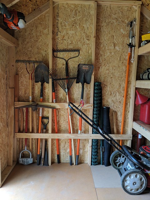 Added some scrap half inch plywood strapping along the studs to hold my long handled garden tools