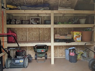 These shelves were much needed. I built the bottom shelf high enough to slip the mower and other ...