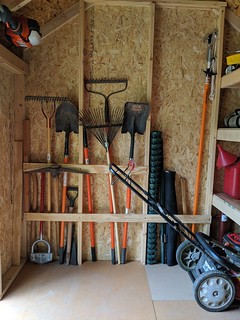 Added some scrap half inch plywood strapping along the studs to hold my long handled garden tools