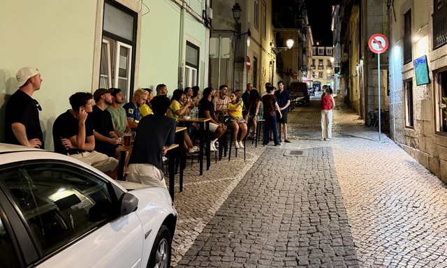 Folks gather around a tiny TV to watch Brasil in the world cup