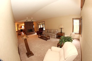 Facing the kitchen from the living room with a gigantic (soon to be demolished) fireplace in betw...