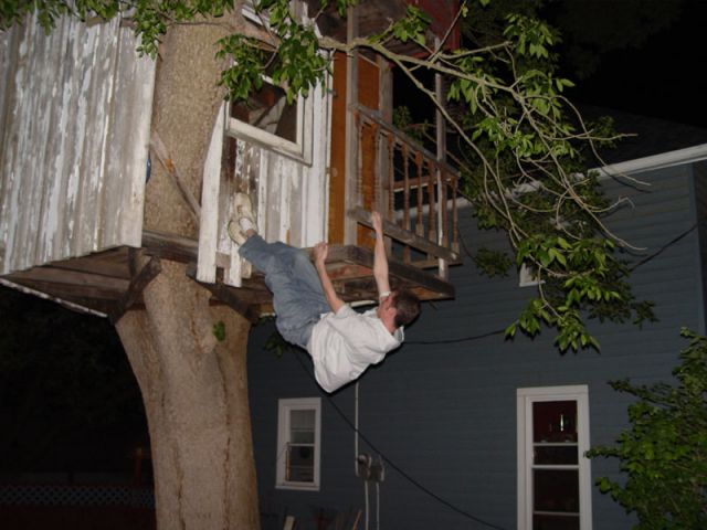 Jeff climbing a tree house monkey style