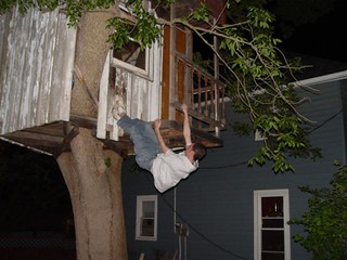 Jeff climbing a tree house monkey style