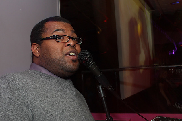 Ando singing with some lovers on the screen