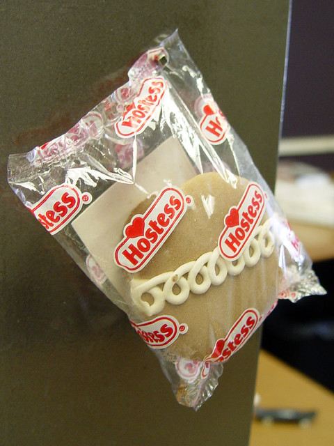 One 1/8" cube magnet is strong enough to hold a 5 year old Hostess Cupcake