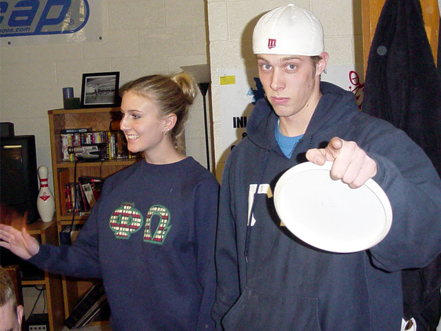 Matt's got a frisbee. That's all I see.  F-R-I-S-B-E-E