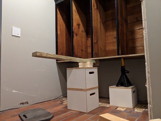 I used fulcrums and jack stands to raise the lockers up for the shoe cubbies to slide underneath