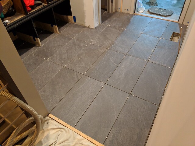 Tiling around the shoe cubbies and closet was a pain in the ass, but I really lucked out on how the tile size worked out with this room. It was almost exactly 6 tiles wide by 4 tiles deep... With a register vent perfectly placed at a seam.