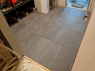 Tiling around the shoe cubbies and closet was a pain in the ass, but I really lucked out on how t...