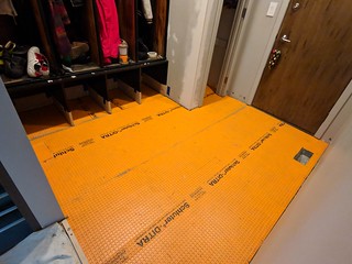 I used 1/8" thick ditra mat for underlayment because I had height constraints with the steel door...