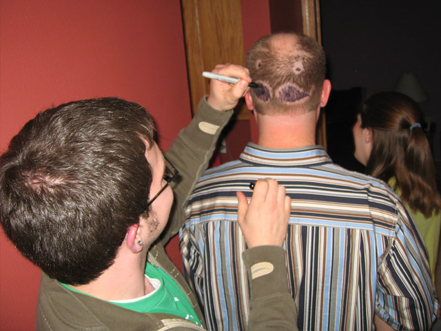 Zach coloring in Rico's "Pringle-Face" with a sharpie