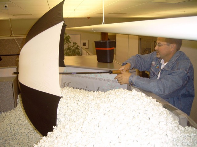 Blair raking with an umbrella