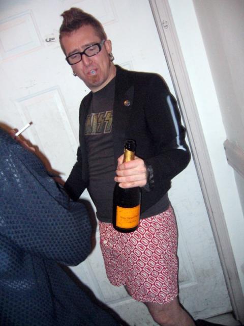 Harper with champagne, a noise maker, and no pants