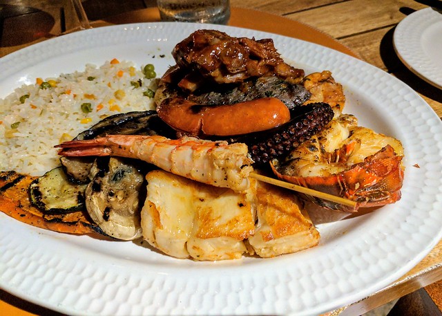 A terrible photo of a ridiculous plate of food. Seasoned chicken, some kind of awesome sausage, w...