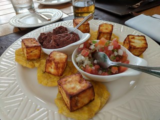Nicaraguan snacks. Fried plantains with fried cheese, beans, and pico de Gallo. So good.