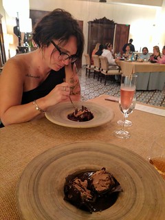 Ice cream wrapped in dark chocolate with some lava chocolate poured over top.