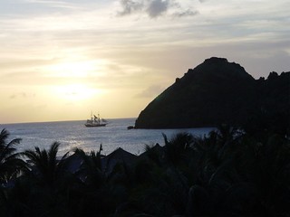 Sunset - Pirate ship sailing past pigeon island