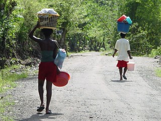 People doing laundry on the outskirts of the forest