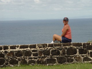 Kari sitting @ Fort Rodney with Martinique in the background
